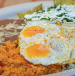 Chilaquiles topped with fried eggs over Mexican rice at El Paisano in Des Moines